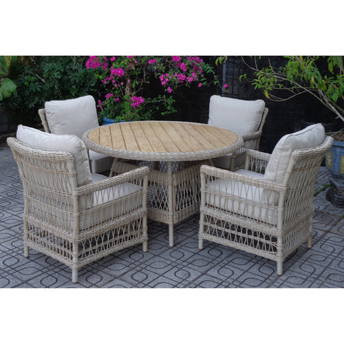 Wicker outdoor furniture set with round table and chairs on a patio
