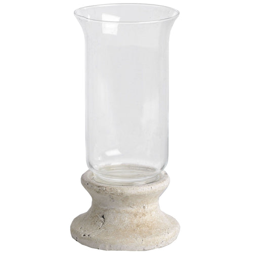 A stone-based hurricane lantern with a clear glass upper part designed to hold candles, featuring a rustic stone-effect base.