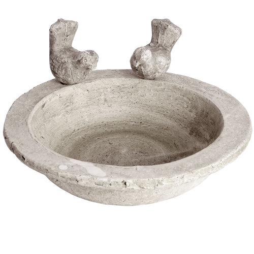 A weathered stone-effect bird bath with a shallow basin and two bird-shaped fixtures on the sides.