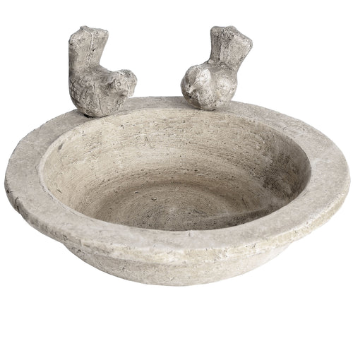 A small bird bath with a stone effect and two bird-shaped protrusions on opposite sides.